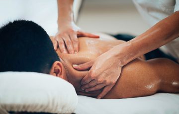 massage therapist performing massage therapy on client's shoulder in angle spa center g9 Islamabad